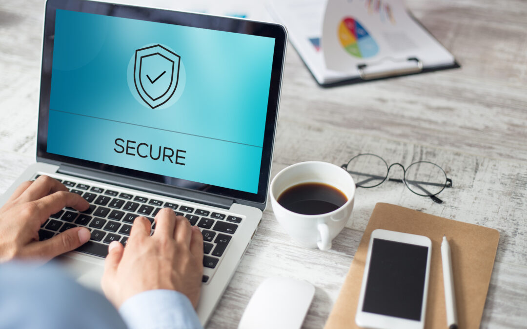 Man typing on a laptop with the word Secure on the screen.