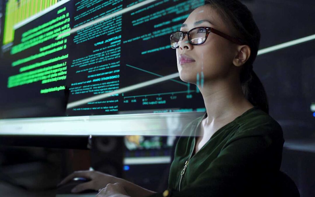 A woman is viewing data on a large screen.