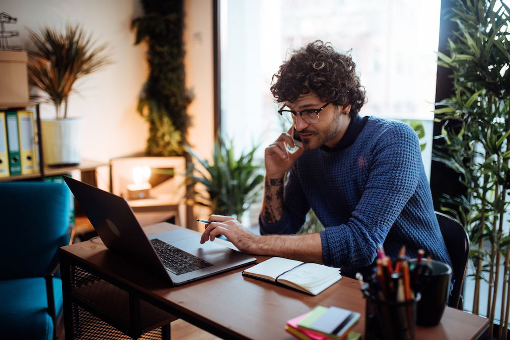 Man talking on the phone in his home office