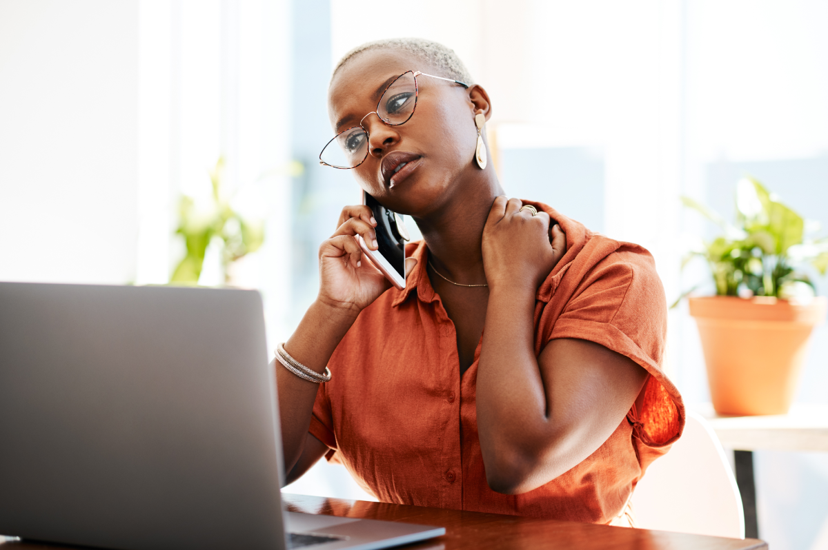 Woman sitting in front of laptop dealing with ID theft