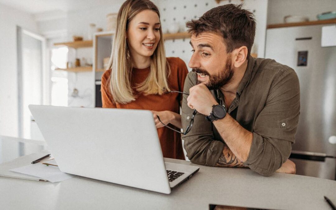 Couple researching credit freezes using a laptop