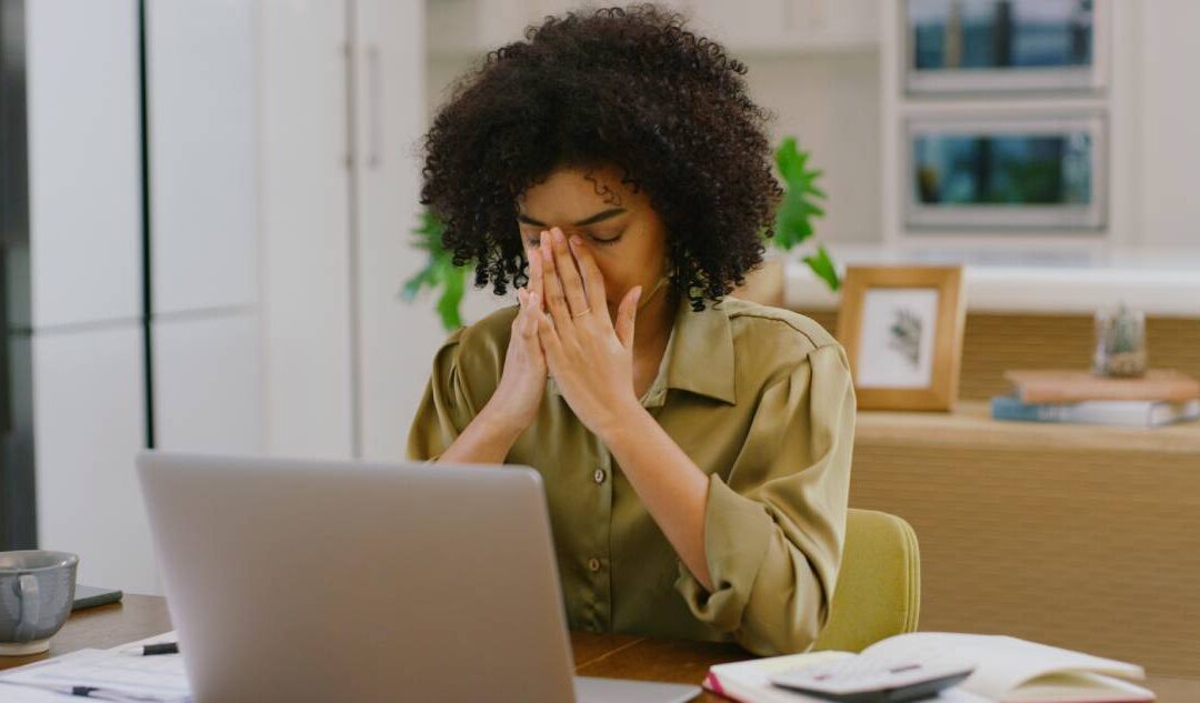 Upset woman who has been hacked looking at her laptop