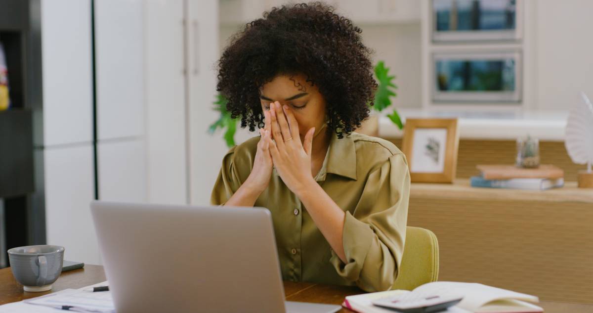 Upset woman who has been hacked looking at her laptop