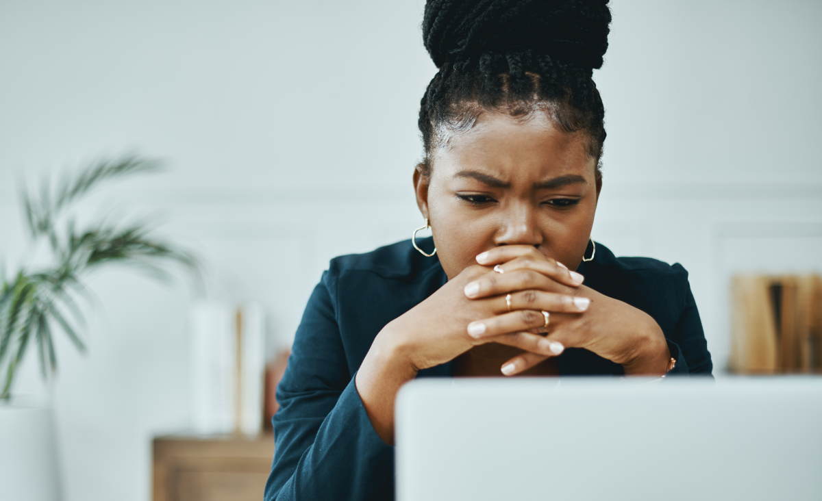 Concerned looking woman viewing email spam on her laptop computer