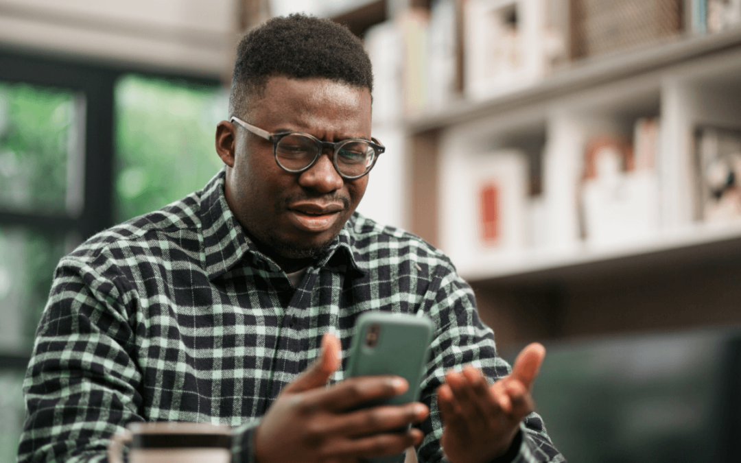 Man realizing his mobile phone has been hacked.