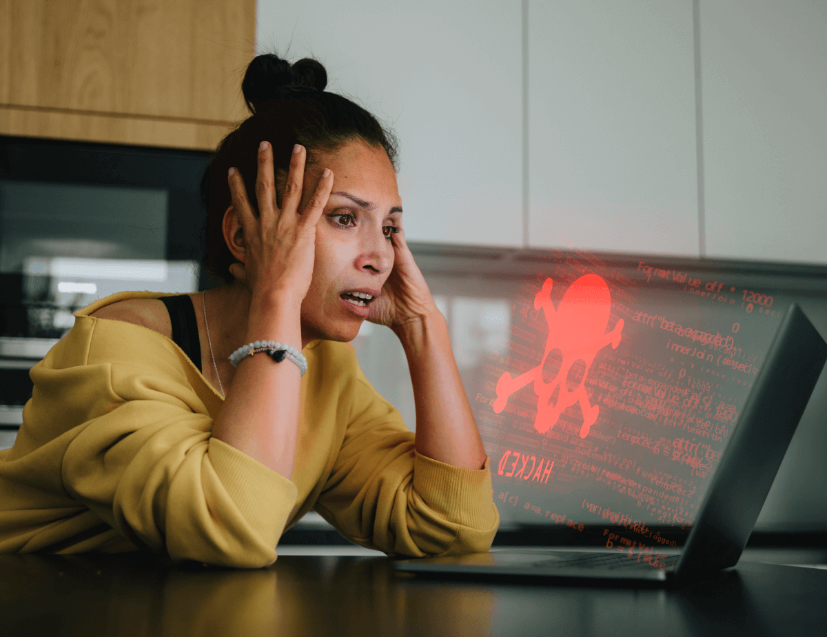 Woman distressed because she is getting a Hacked message on her desktop computer.