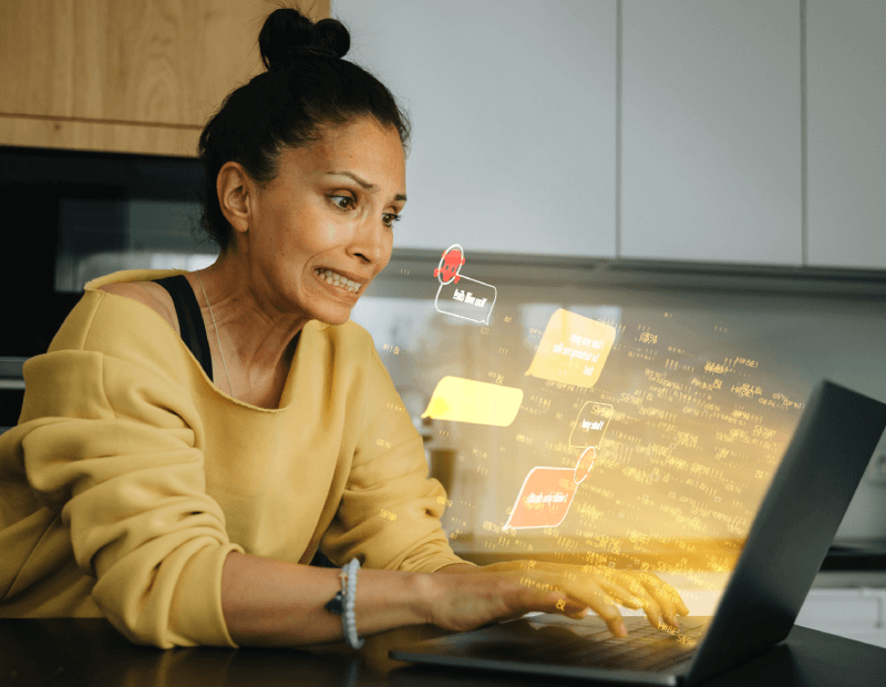 Woman worried as she realizes her laptop computer may have been hacked.