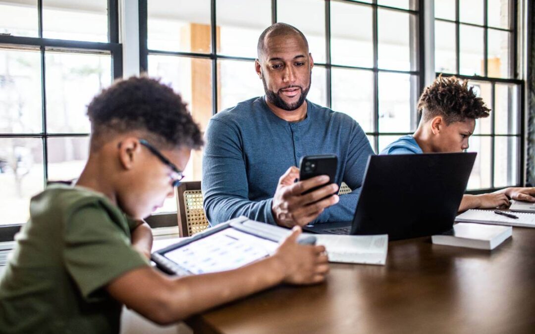 Father and sons doing social media cleanse on their devices.