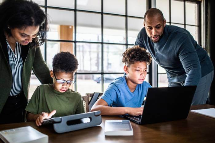 Mother and father helping their two boys with social media cleanup and security.