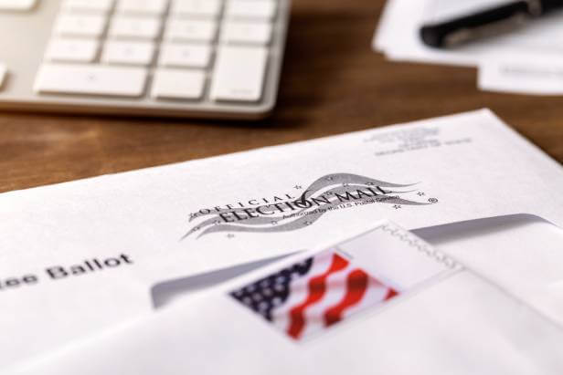 A stamped envelope marked as Official Election Mail. How to prevent identity theft during election.