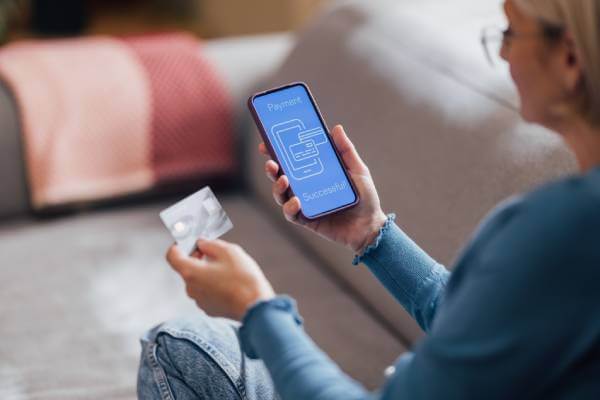 Woman using her phone for a successful online payment.